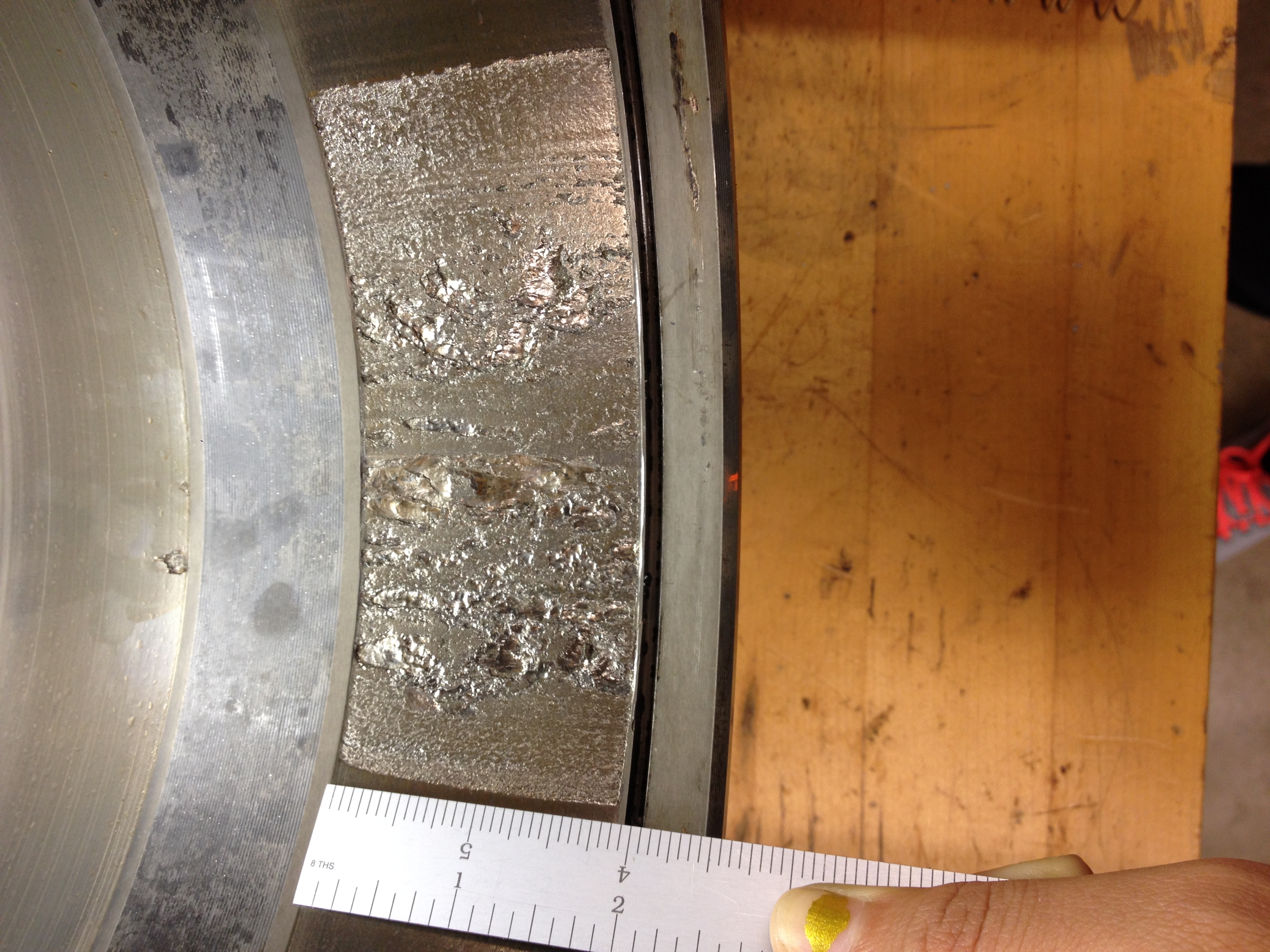 A spall of size 8.08 in² on a cup.